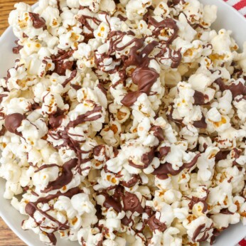 chocolate drizzled popcorn on a pan