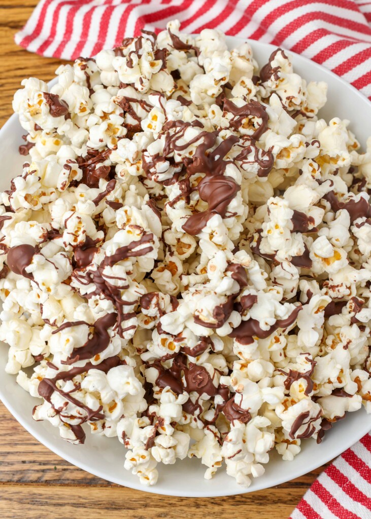 chocolate drizzled popcorn on a pan