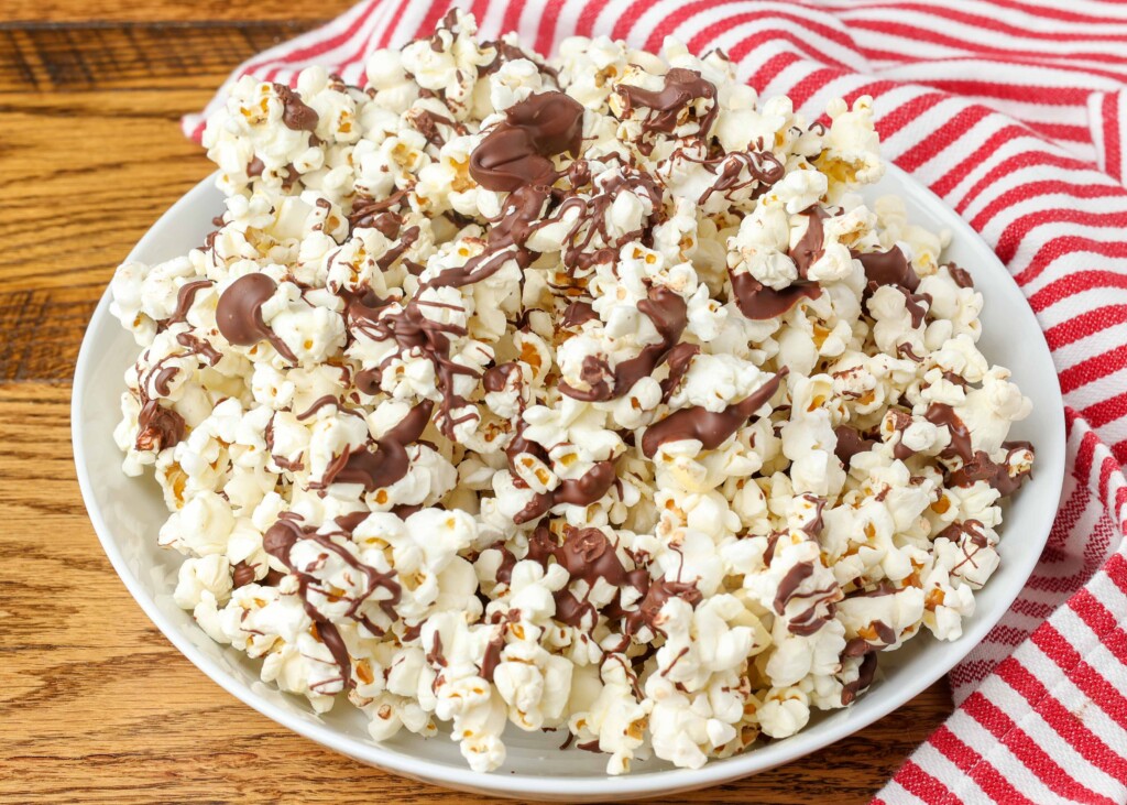 chocolate drizzled popcorn on a pan