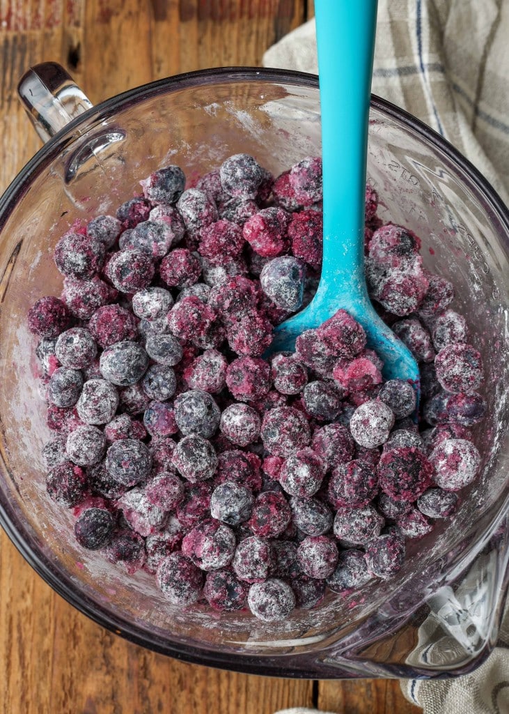 sugar and flour coated blueberries in mixing bowl