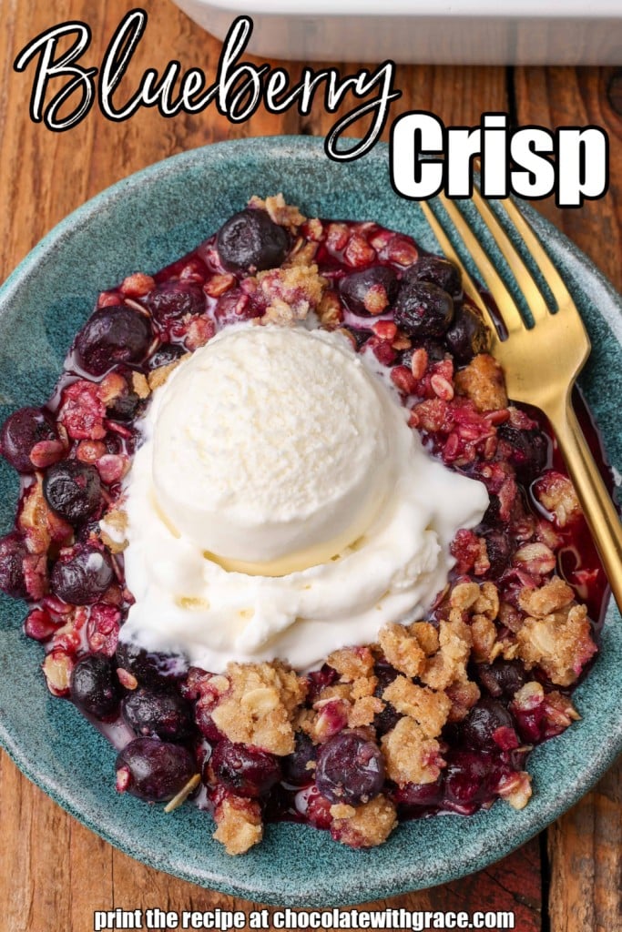 berry crisp with ice cream on blue pottery dish with gold fork