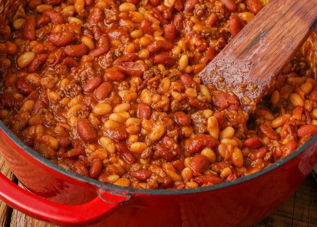 close up of baked beans in red enamel pot