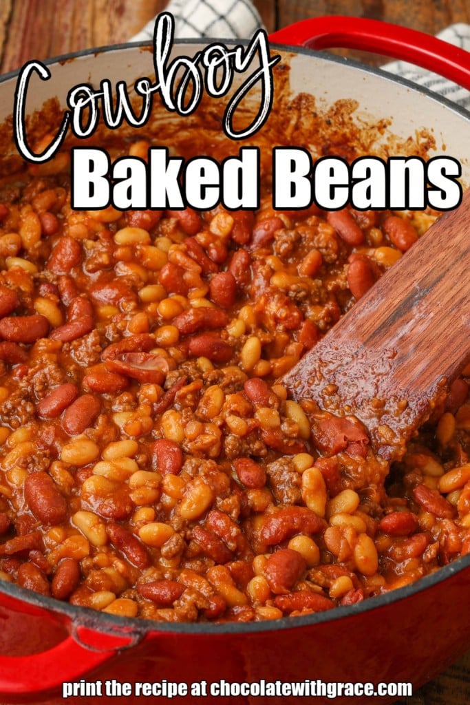 close up of baked beans in red pot with spoon