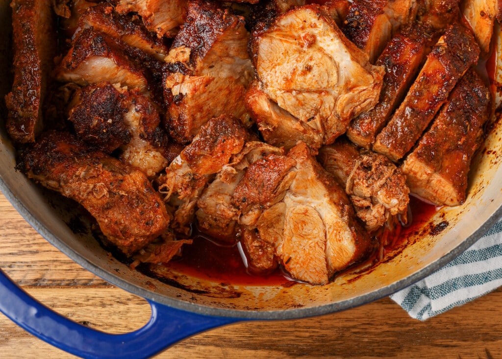 dutch oven roasted pork shoulder in a blue dutch oven