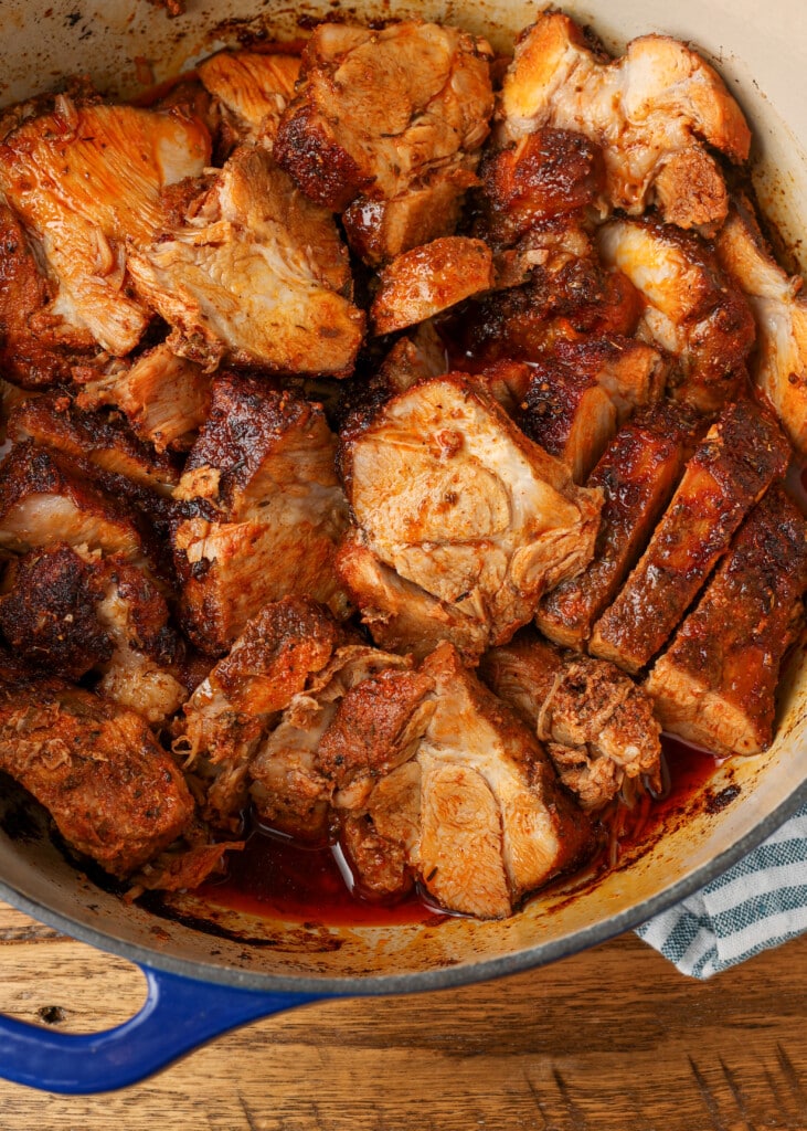 dutch oven roasted pork shoulder in a blue dutch oven