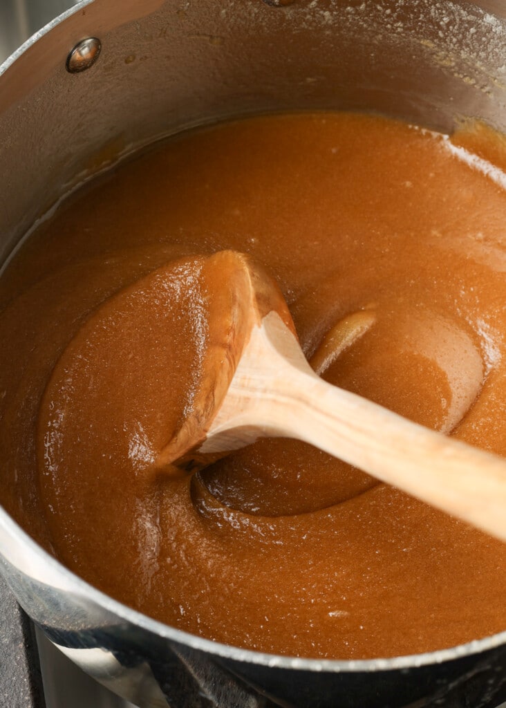 brown sugar being melted into butter in a saucepan