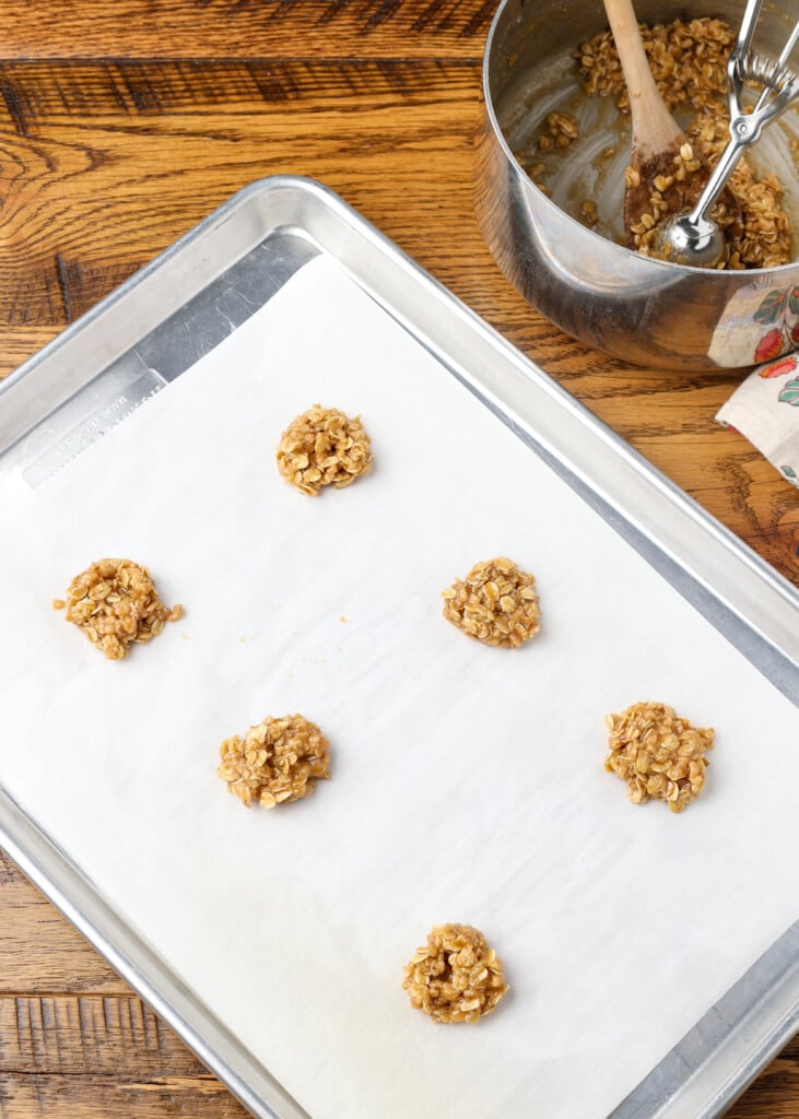 cookie dough balls on parchment on baking sheet