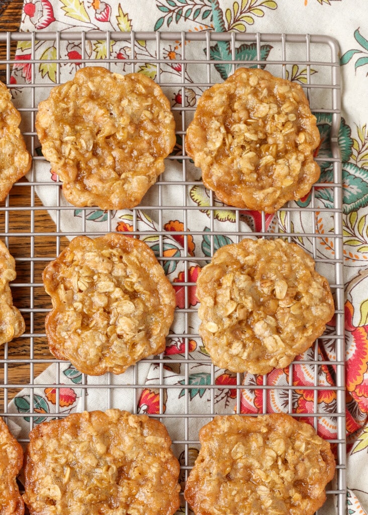 ultra thin oatmeal cookies cooling on rack with napkin underneath