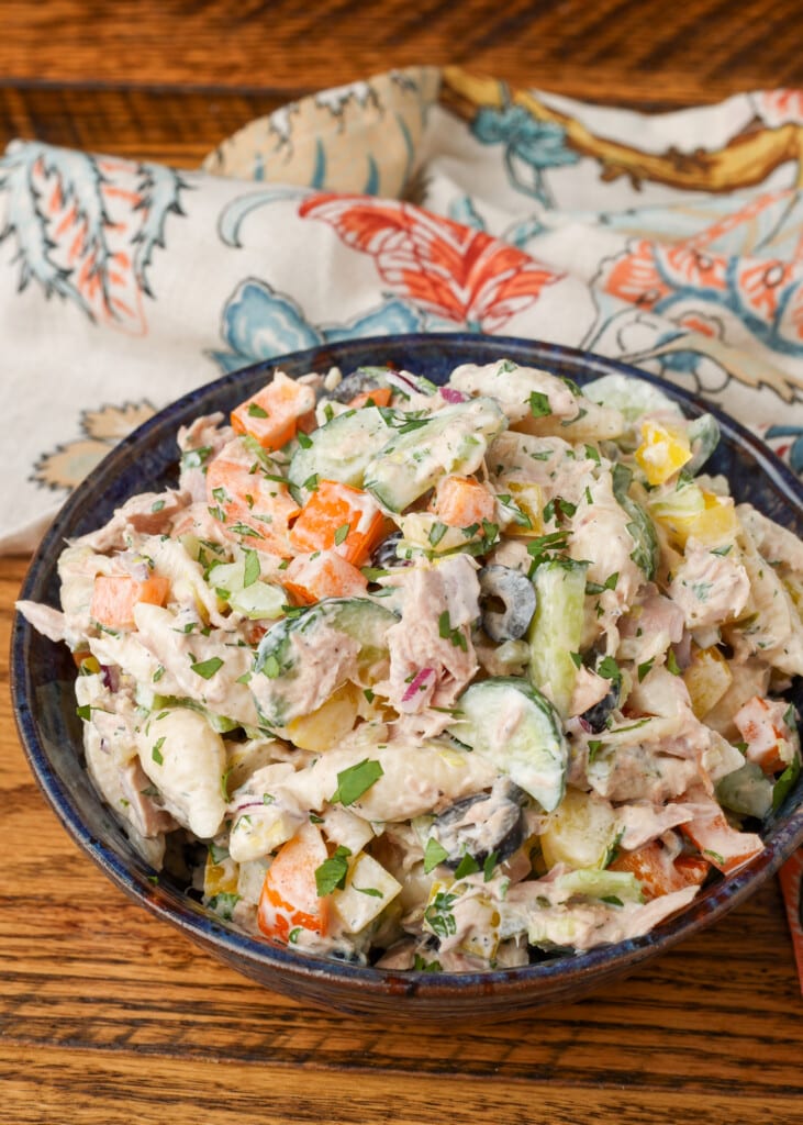 serving of pasta salad in black bowl on wooden table