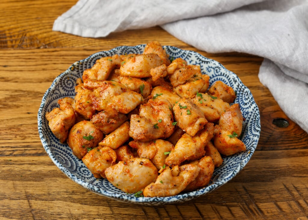 chicken bites in blue dish on wooden table