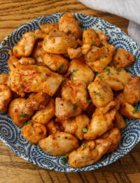 overhead shot of chicken bites in shallow blue bowl