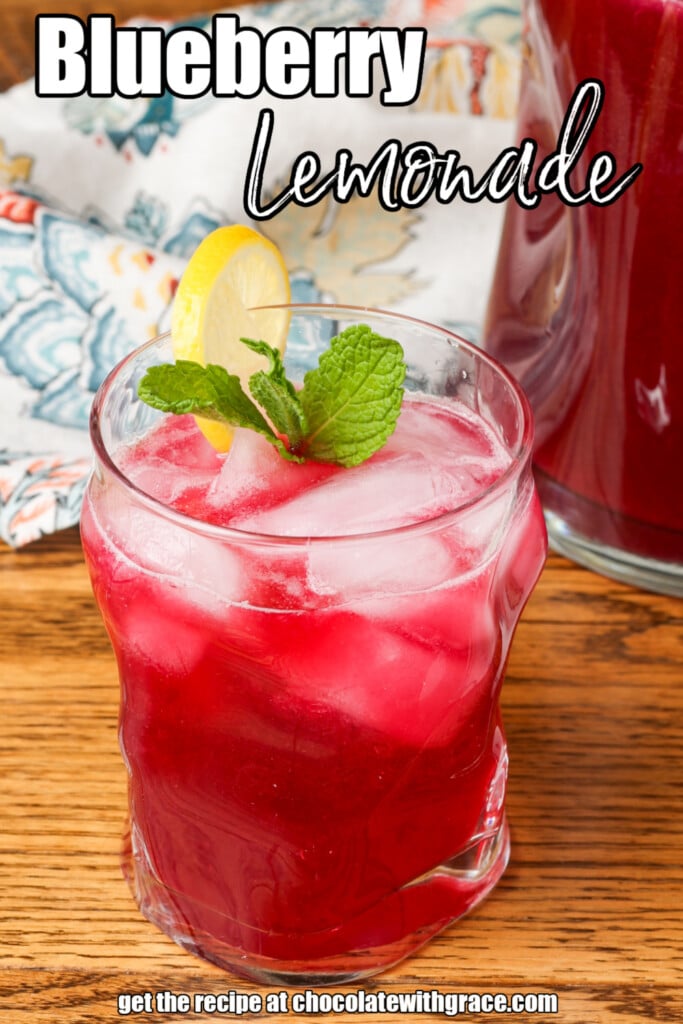 blueberry lemonade in a glass garnished with lemon and mint with text overlay describing the photo
