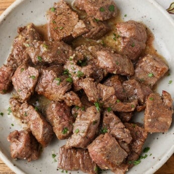 horizontal photo of steak bites on pottery plate