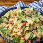 vertical photo of pasta salad in blue bowl
