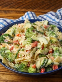 vertical photo of pasta salad in blue bowl