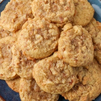 A top down close up of cookies on a blue and black plate with a tea towel around it.
