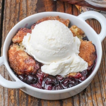 blueberry cobbler in round bowl with ice cream