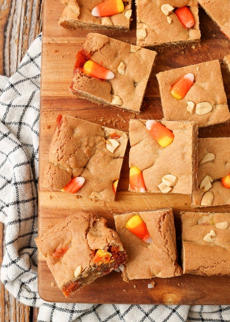 blondies with candy corn on cutting board with black and white towel