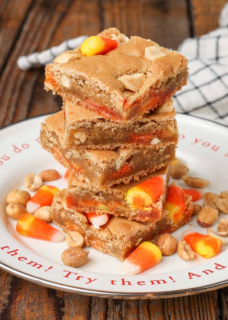 candy corn filled blondies stacked on cute plate with plaid towel