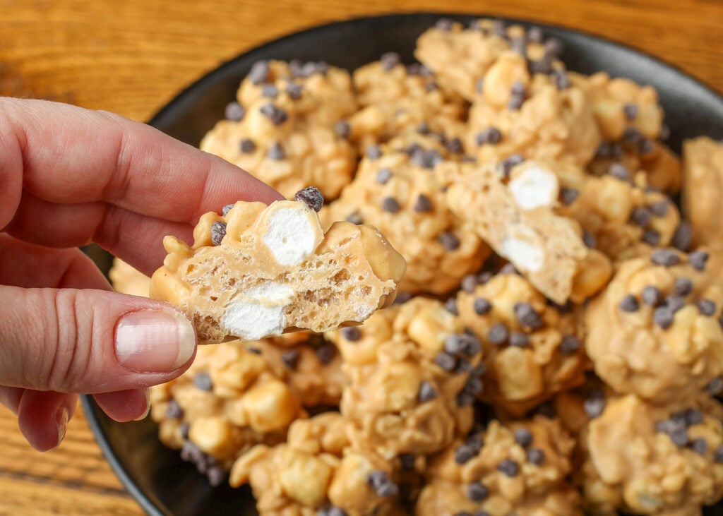 An avalanche cookie has been split in half to reveal the crumb and the marshmallows within.