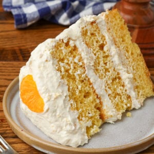 pig picking cake sliced on plate with orange wedge
