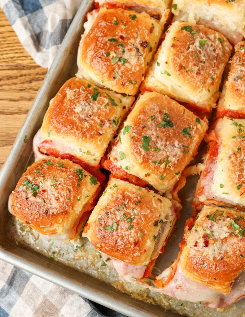 A vertically aligned image of the sliced, finished product, showing chicken parm sliders that are ready to eat!