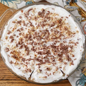 A horizontally aligned top down close up of the possum pie, finished with crushed nuts and shaved chocolate.